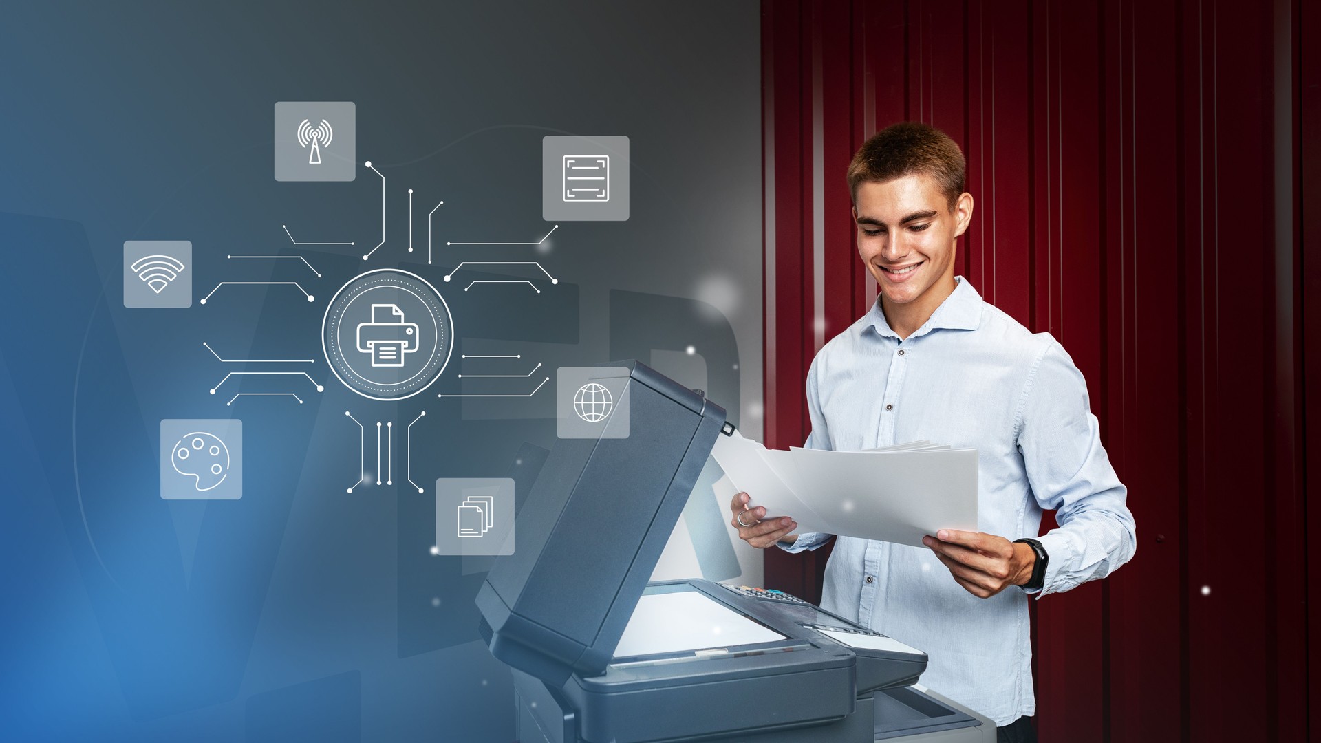 Young man using a multifunction printer in an office setting while reviewing printed documents and accessing digital features