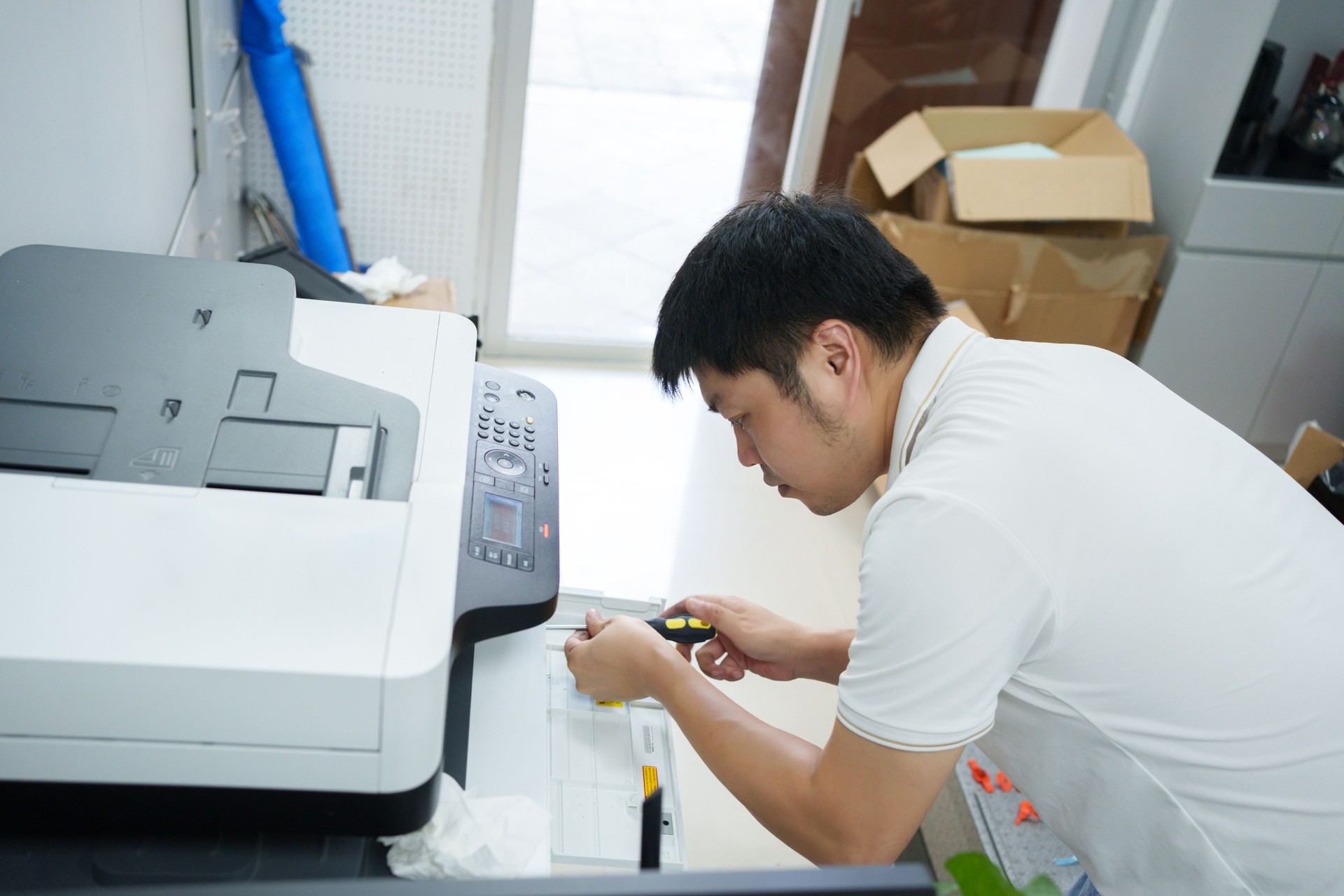 Worker repairing printer